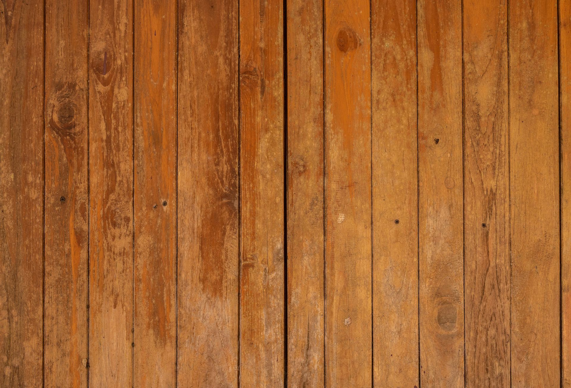 A close up of a wooden wall with a lot of wood grain.
