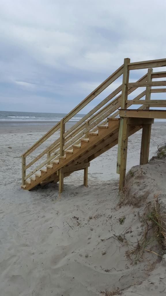 A wooden staircase leading up to the beach.