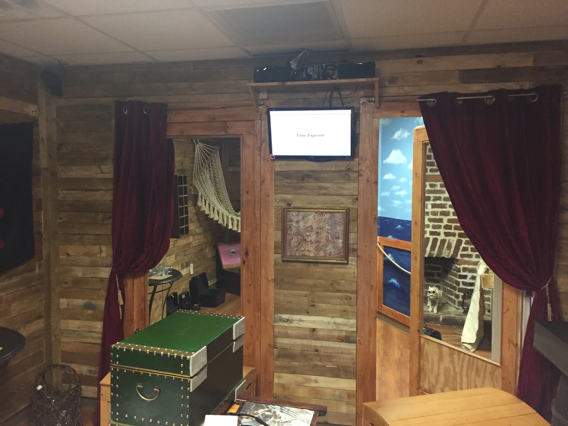 A room with wooden walls and a television on the wall