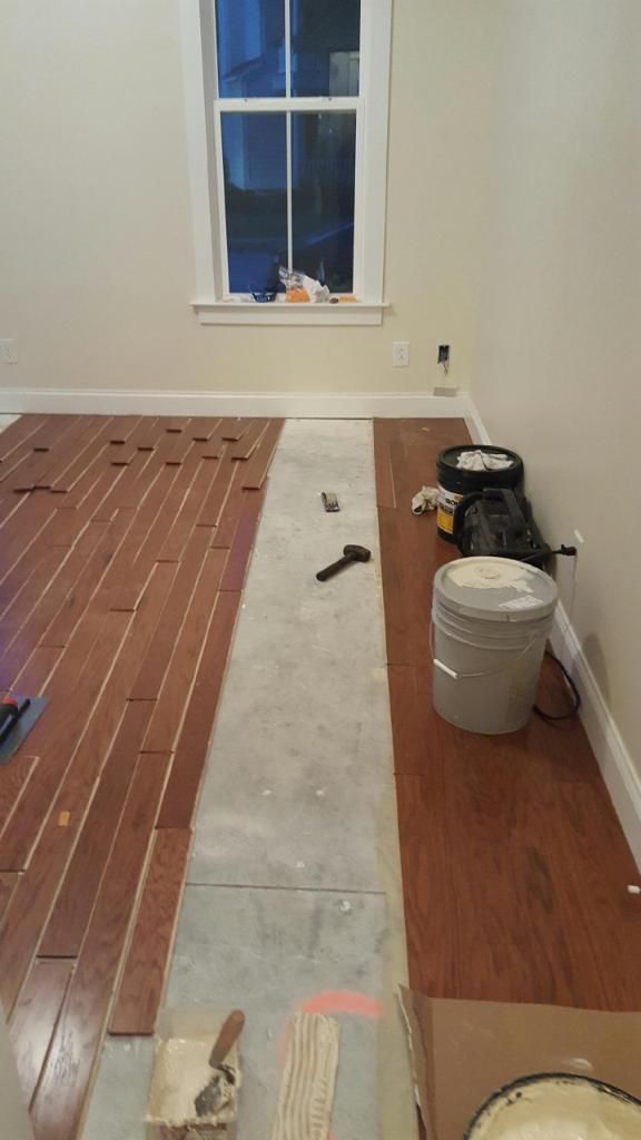 A room with a wooden floor and a window.