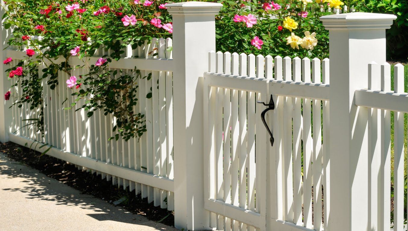 a man is using a drill on a wooden fence