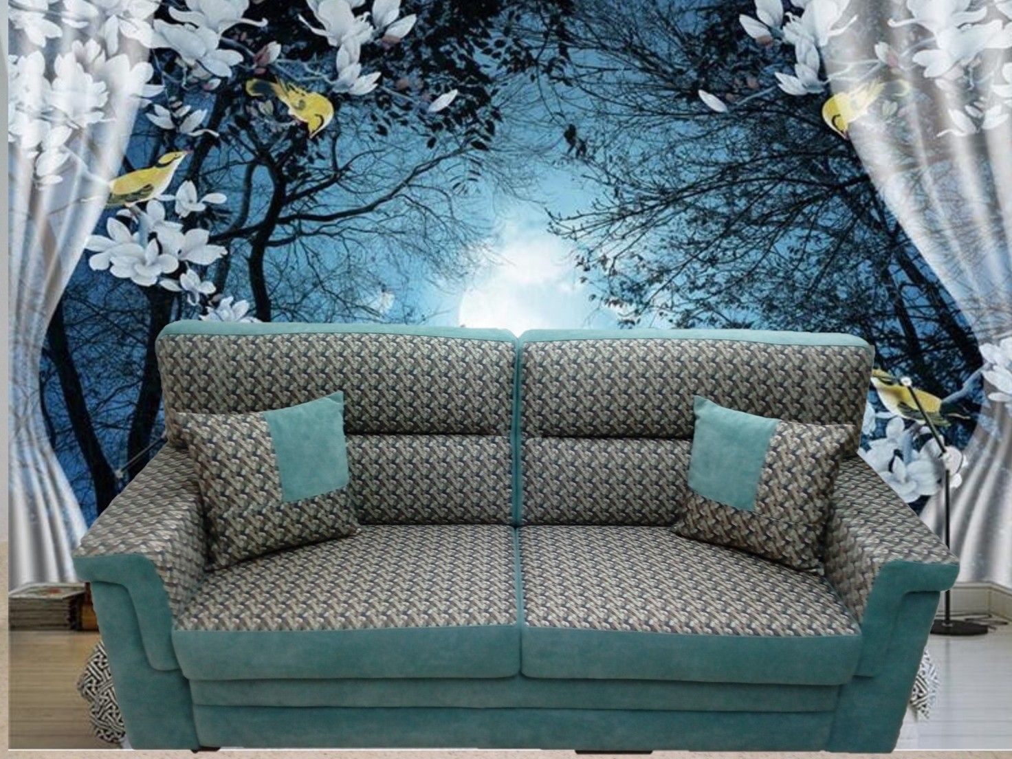 Divano con fantasia verde acqua e cuscini verde acqua di fronte a un murale raffigurante una foresta blu con accenti floreali bianchi.