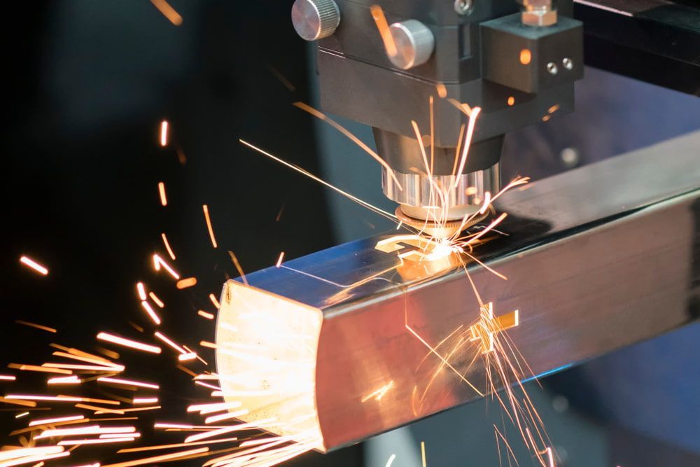 A Machine Is Cutting A Piece Of Metal With Sparks Coming Out Of It — HardRok Engineering Pty Ltd In Mount Isa, QLD