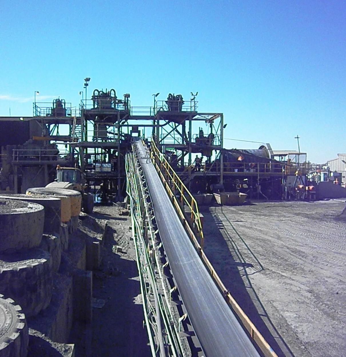 A Conveyor Belt In A Factory With A Blue Sky In The Background — HardRok Engineering Pty Ltd in Mount Isa, QLD