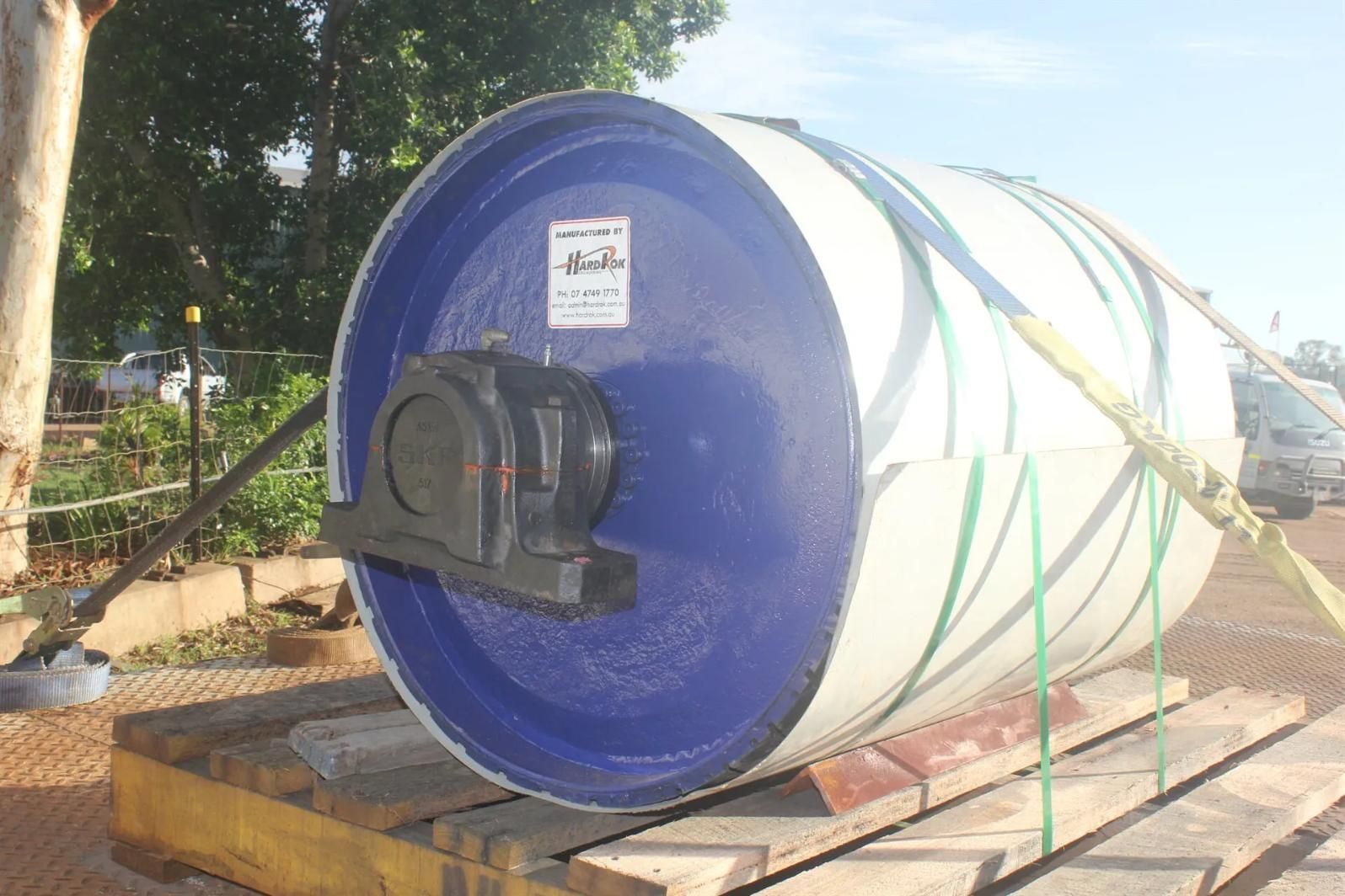 A Large Blue And White Barrel Is Sitting On A Wooden Pallet — HardRok Engineering Pty Ltd In Mount Isa, QLD