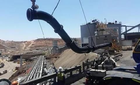 A Large Pipe Is Being Lifted By A Crane In A Factory — HardRok Engineering Pty Ltd In Mount Isa, QLD