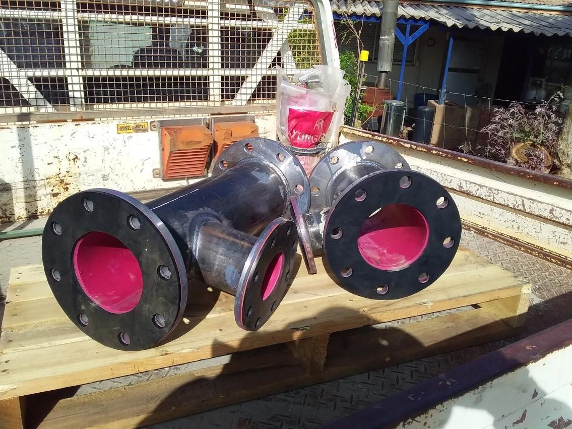 A Couple Of Pipes Sitting On Top Of A Wooden Pallet — HardRok Engineering Pty Ltd In Mount Isa, QLD