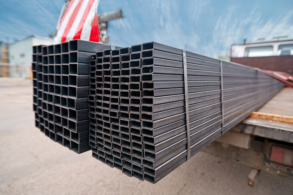 A Stack Of Metal Pipes Sitting On Top Of A Truck — HardRok Engineering Pty Ltd In Mount Isa, QLD