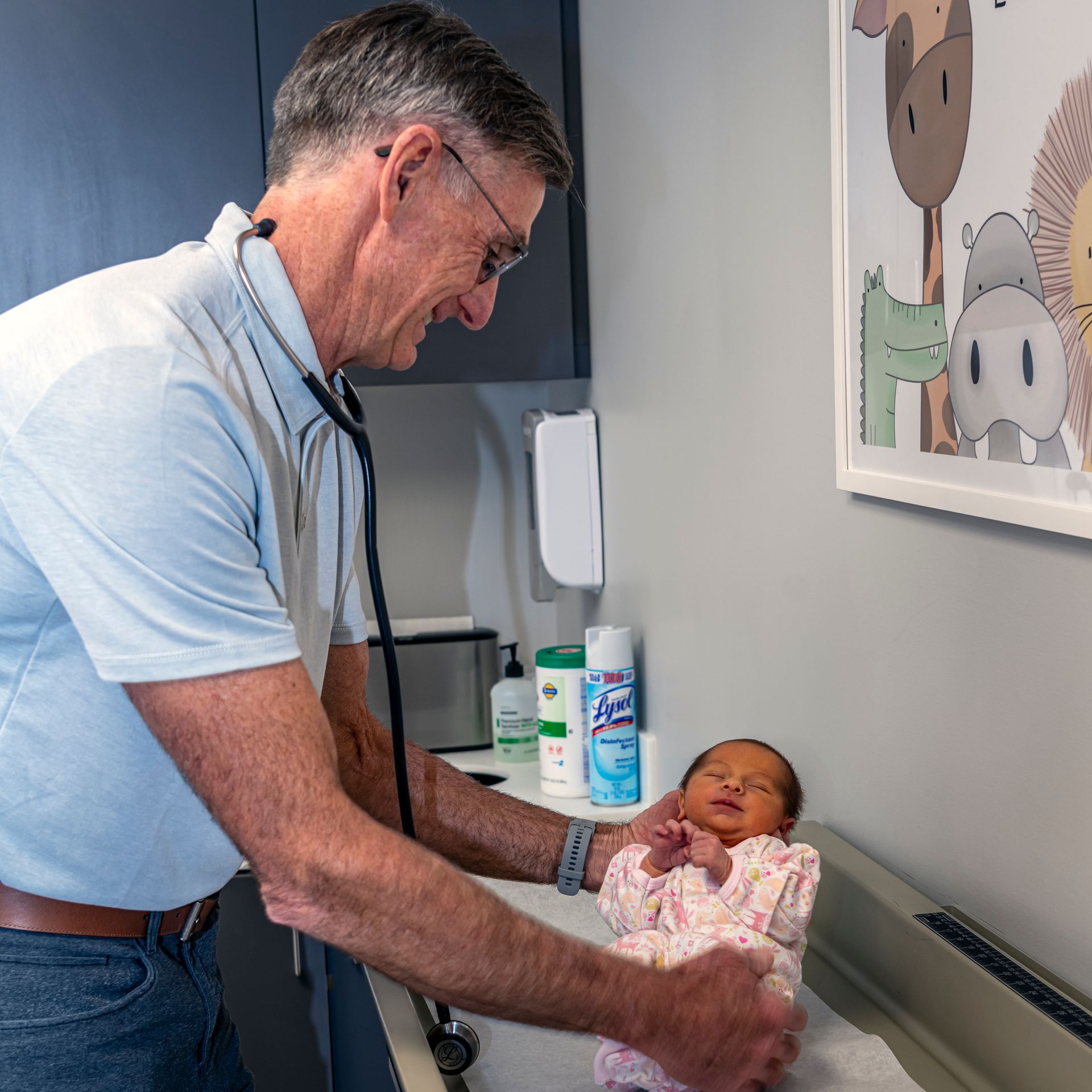 Pediatrician examining a baby by listening to the baby's heartbeat