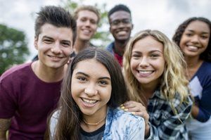 A group of young people are posing for a picture together.