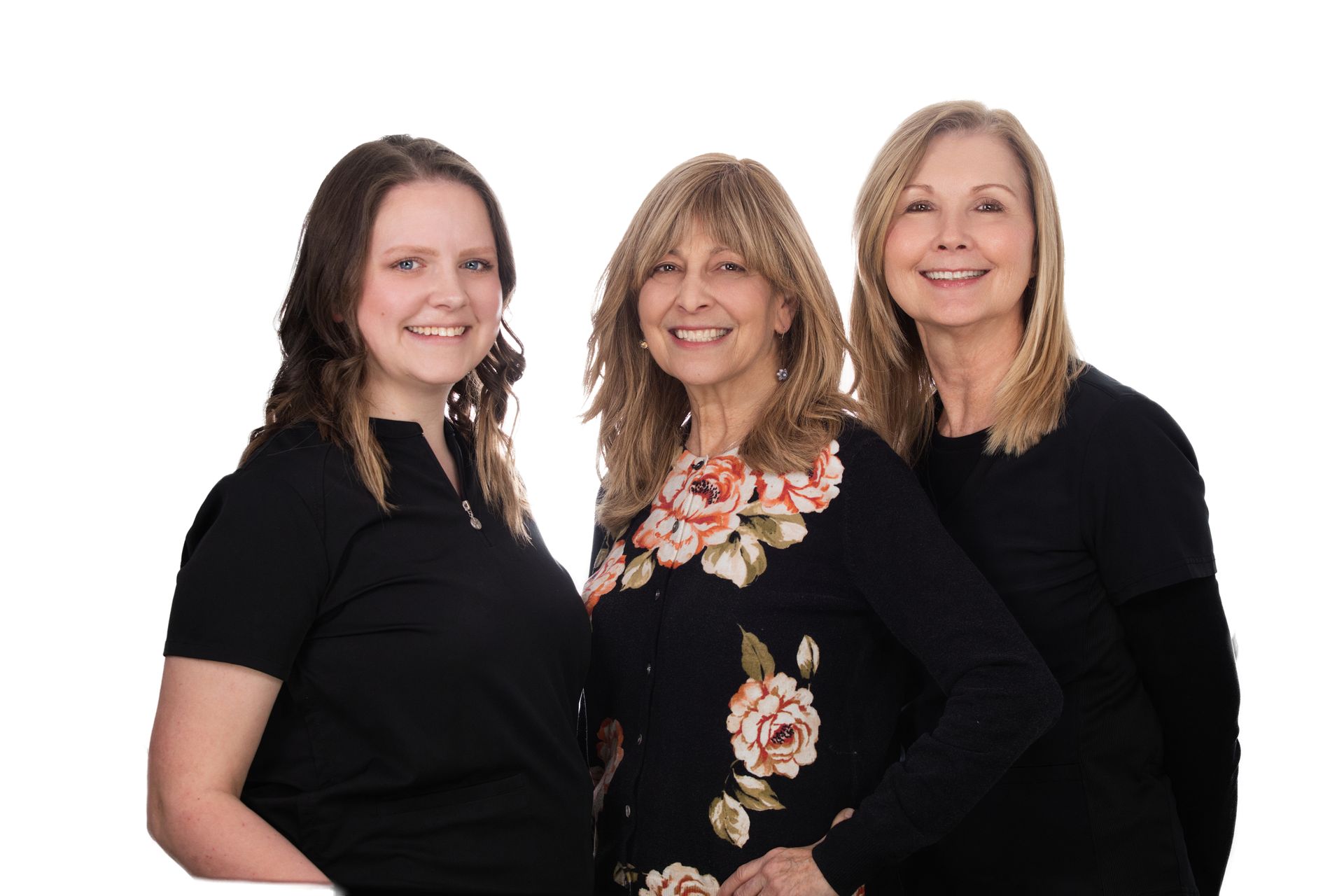 Three newborn care & lactation support professionals posing together on a white background.