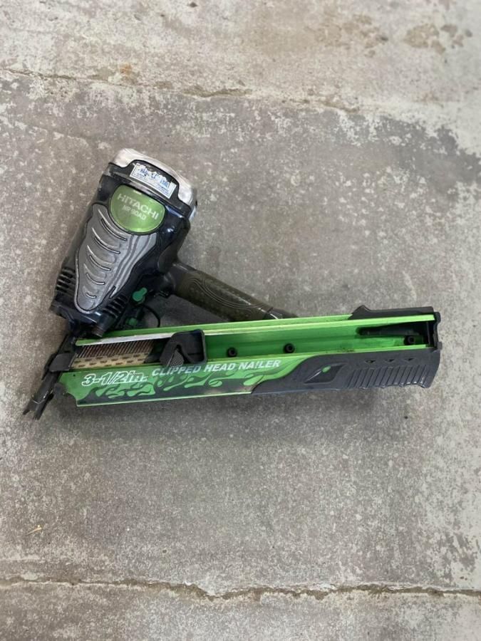 A Green and Black Stapler is Sitting on a Concrete Surface — Hamblin Hire in Albury, NSW