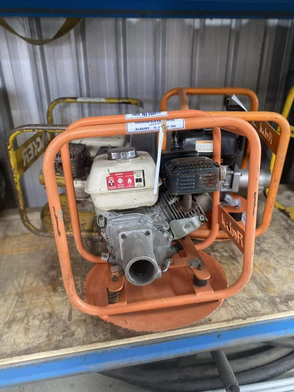 A Small Engine is Sitting on Top of a Wooden Table — Hamblin Hire in Albury, NSW