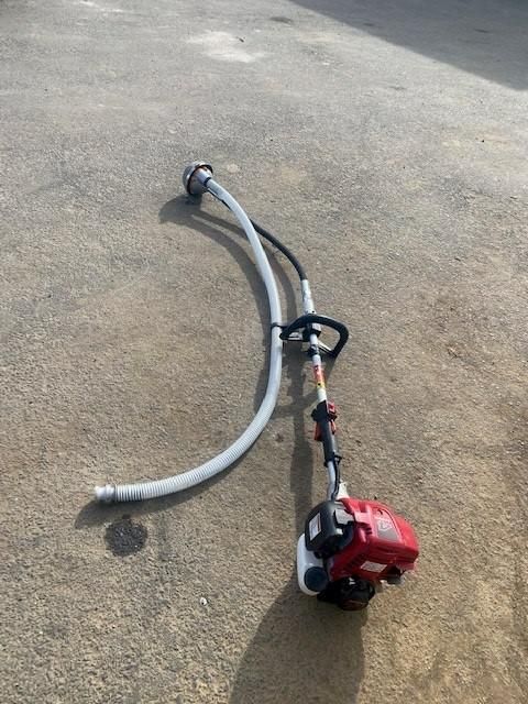 A Lawn Mower With a Hose Attached to It is Sitting on the Ground — Hamblin Hire in Albury, NSW