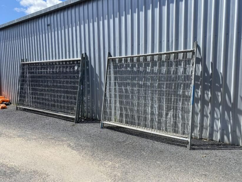 Two Metal Fences Are Sitting in Front of a Building — Hamblin Hire in Albury, NSW