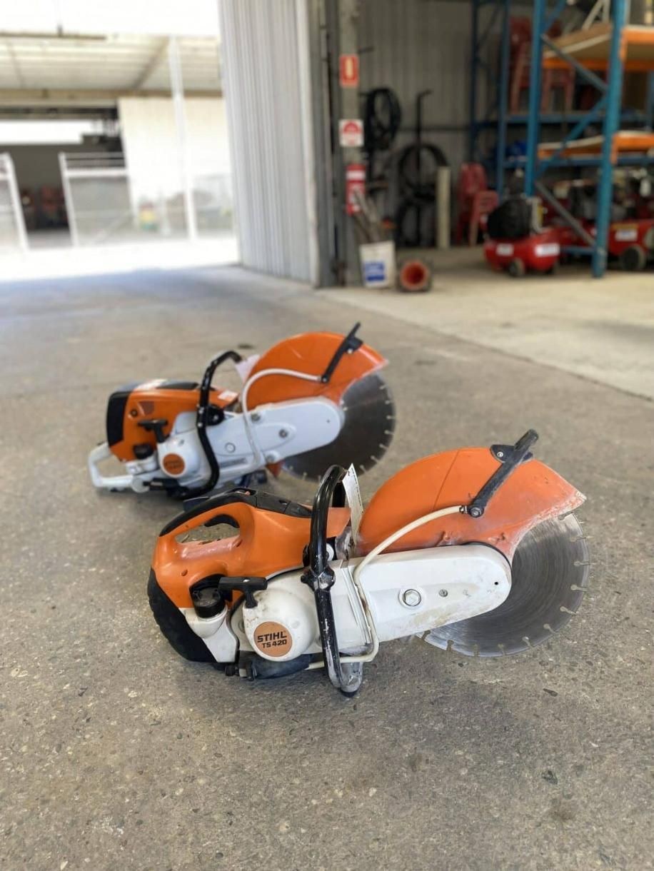Two Circular Saws Are Sitting on the Ground in a Garage — Hamblin Hire in Albury, NSW