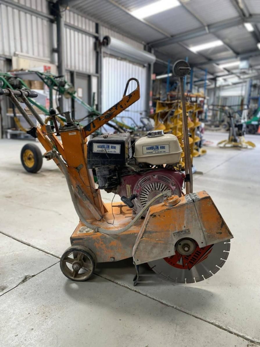 A Concrete Saw is Sitting on the Floor in a Warehouse — Hamblin Hire in Albury, NSW