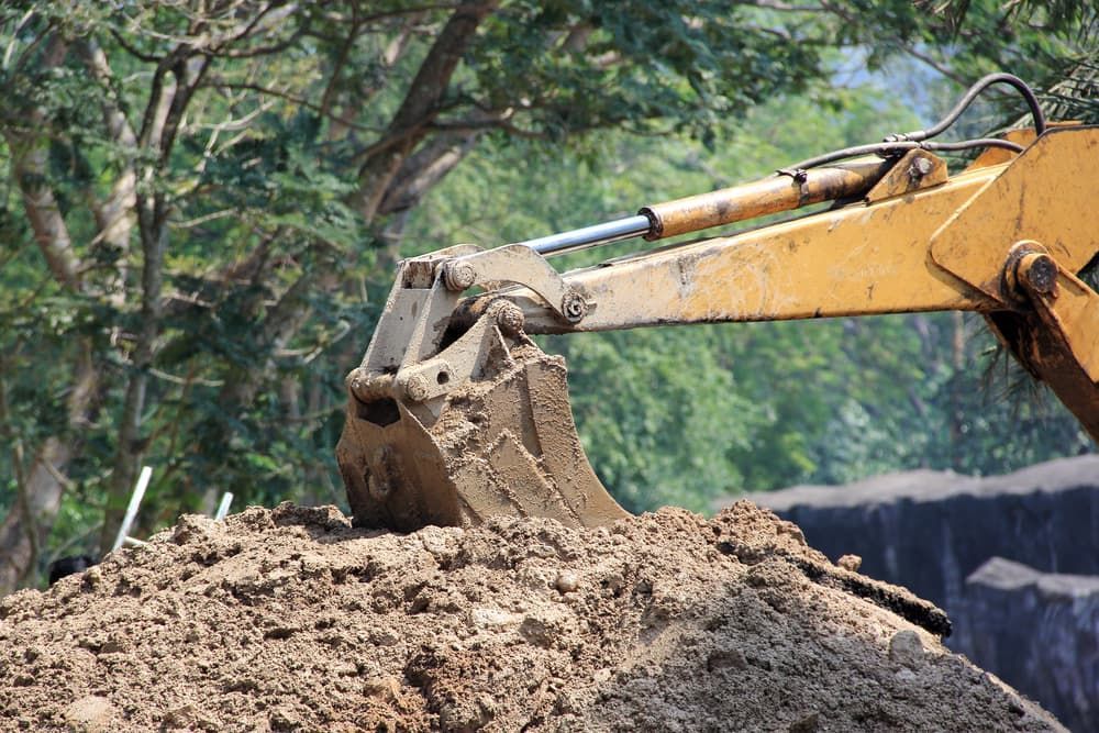 A Bulldozer is Digging a Pile of Dirt — Hamblin Hire in Albury, NSW