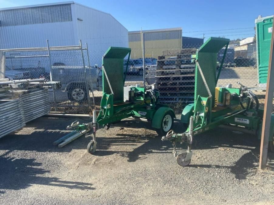 A Green Machine is Parked in a Dirt Lot in Front of a Building — Hamblin Hire in Albury, NSW