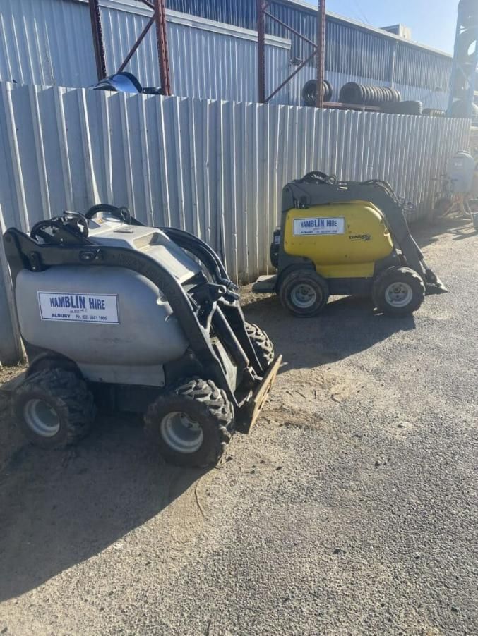 Two Small Tractors Are Parked Next to Each Other in a Parking Lot — Hamblin Hire in Albury, NSW