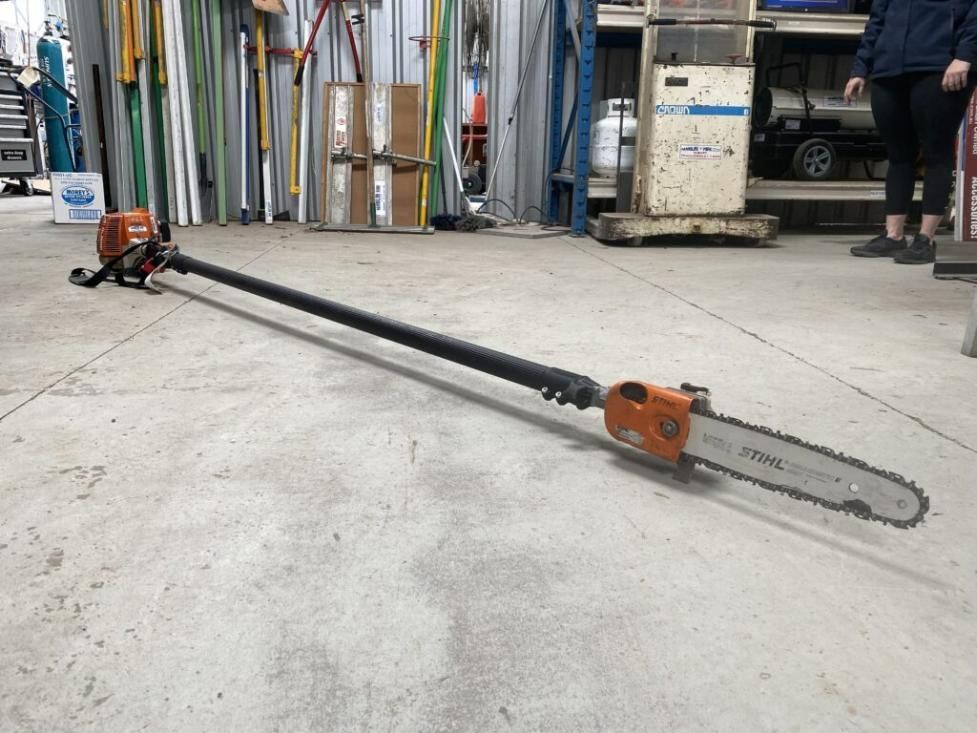 A Pole Saw is Sitting on the Floor in a Garage — Hamblin Hire in Albury, NSW