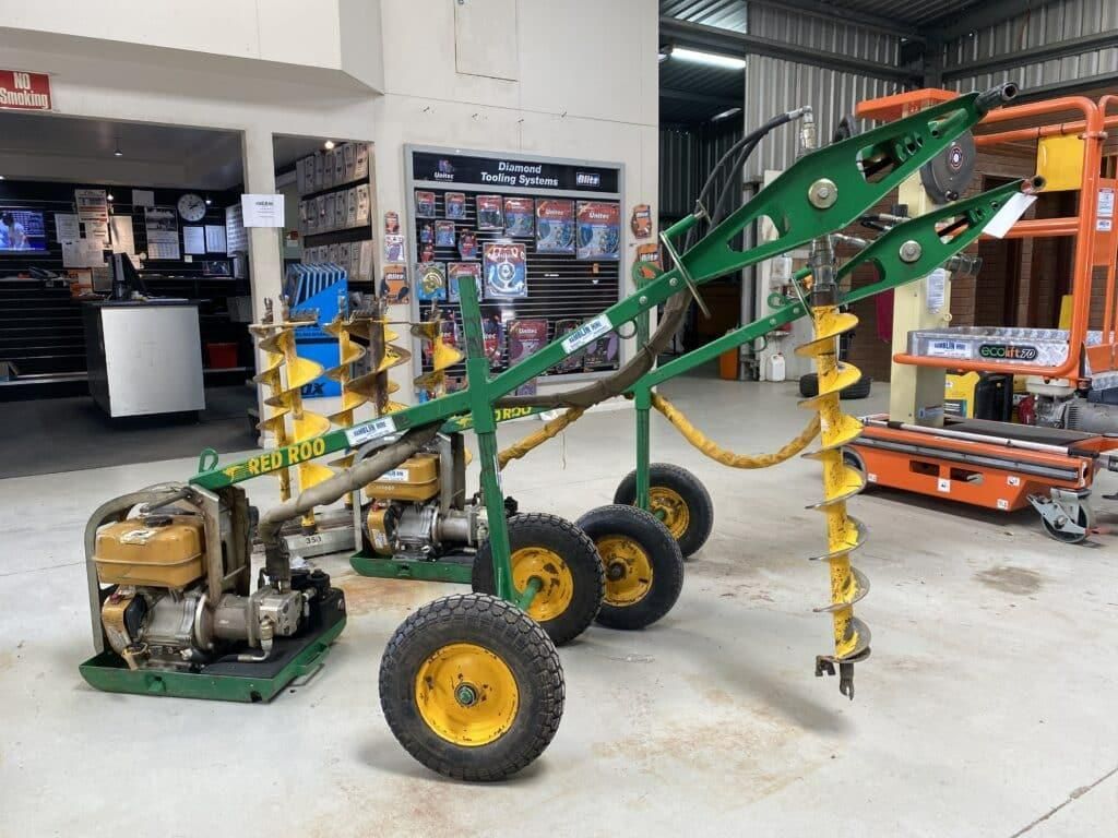 A Green and Yellow Machine With Wheels is Sitting in a Warehouse — Hamblin Hire in Albury, NSW