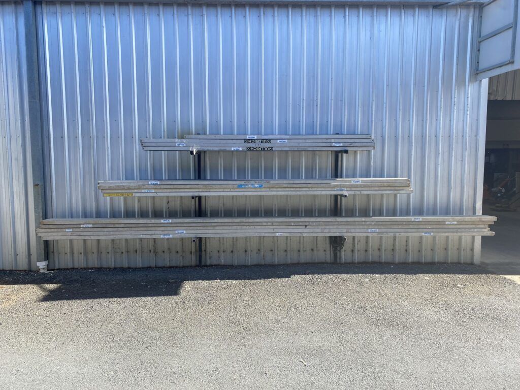 A Metal Building With a Row of Shelves on the Side of It — Hamblin Hire in Albury, NSW