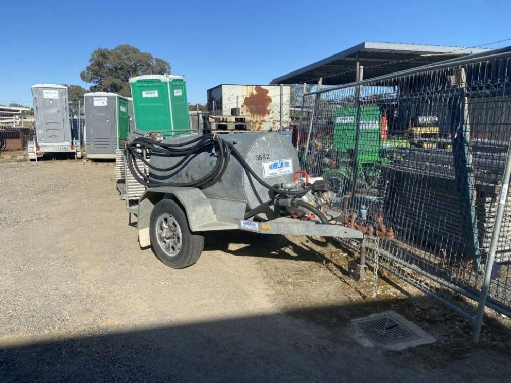 A Trailer With a Hose Attached to It is Parked in a Parking Lot — Hamblin Hire in Albury, NSW