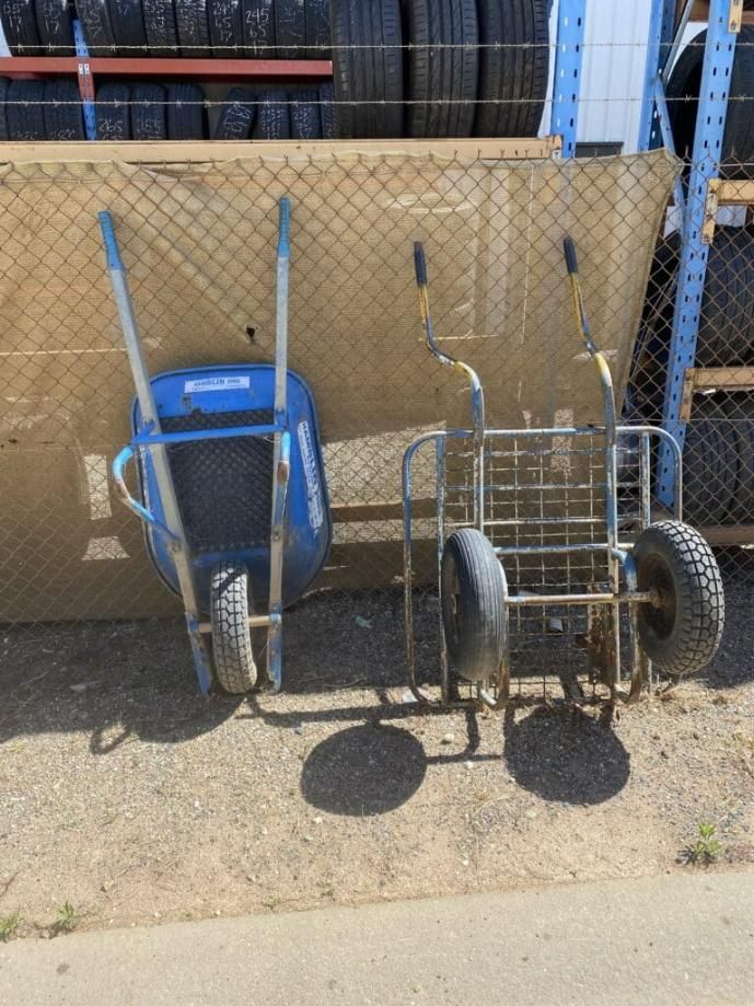 Two Wheelbarrows Are Sitting Next to Each Other in Front of a Chain Link Fence — Hamblin Hire in Albury, NSW