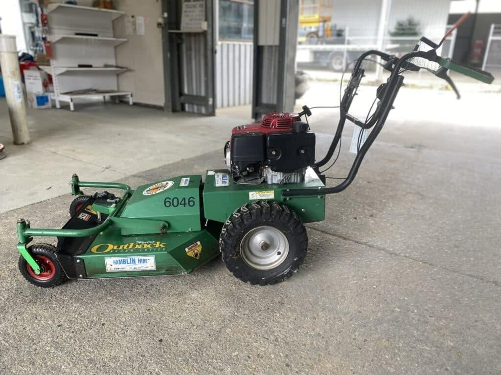 A Green Lawn Mower is Parked in a Parking Lot — Hamblin Hire in Albury, NSW