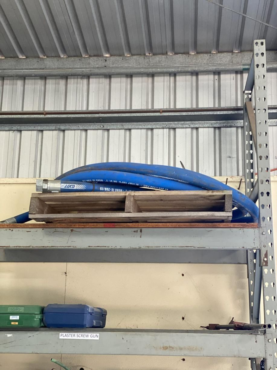 A Blue Hose is Sitting on Top of a Wooden Pallet on a Shelf — Hamblin Hire in Albury, NSW