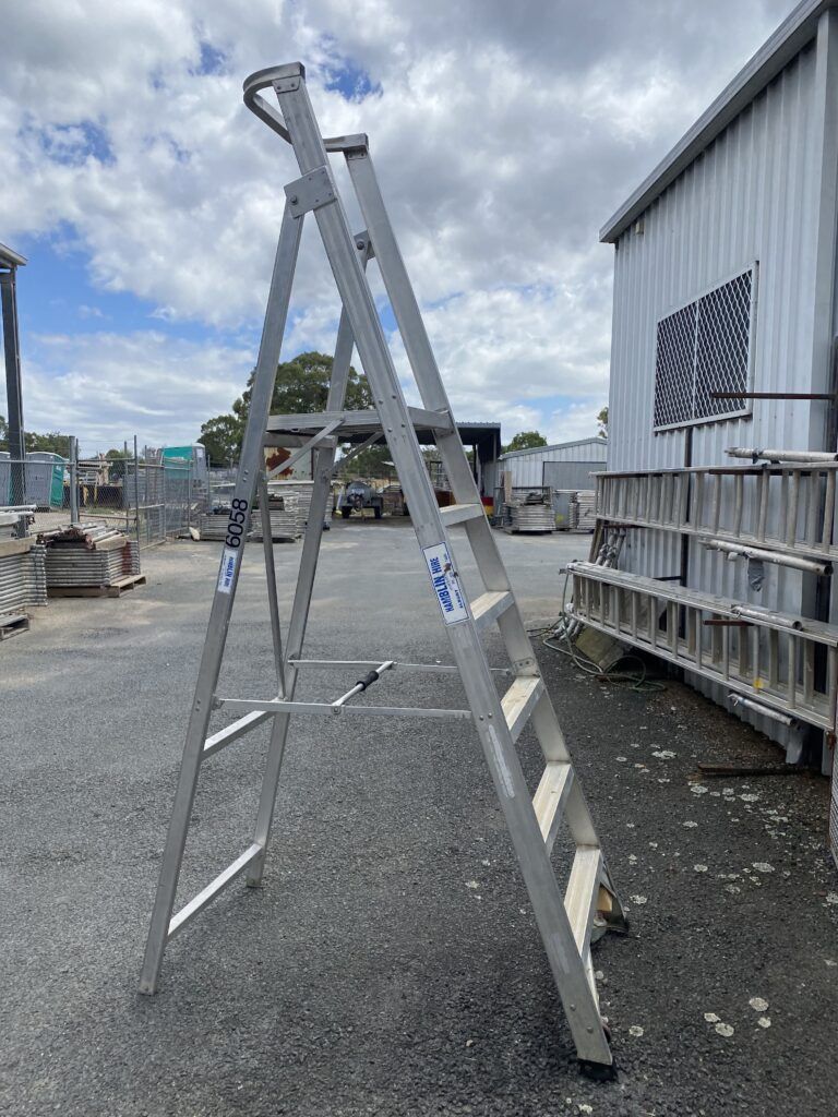 A Ladder is Sitting on the Ground in Front of a Building — Hamblin Hire in Albury, NSW