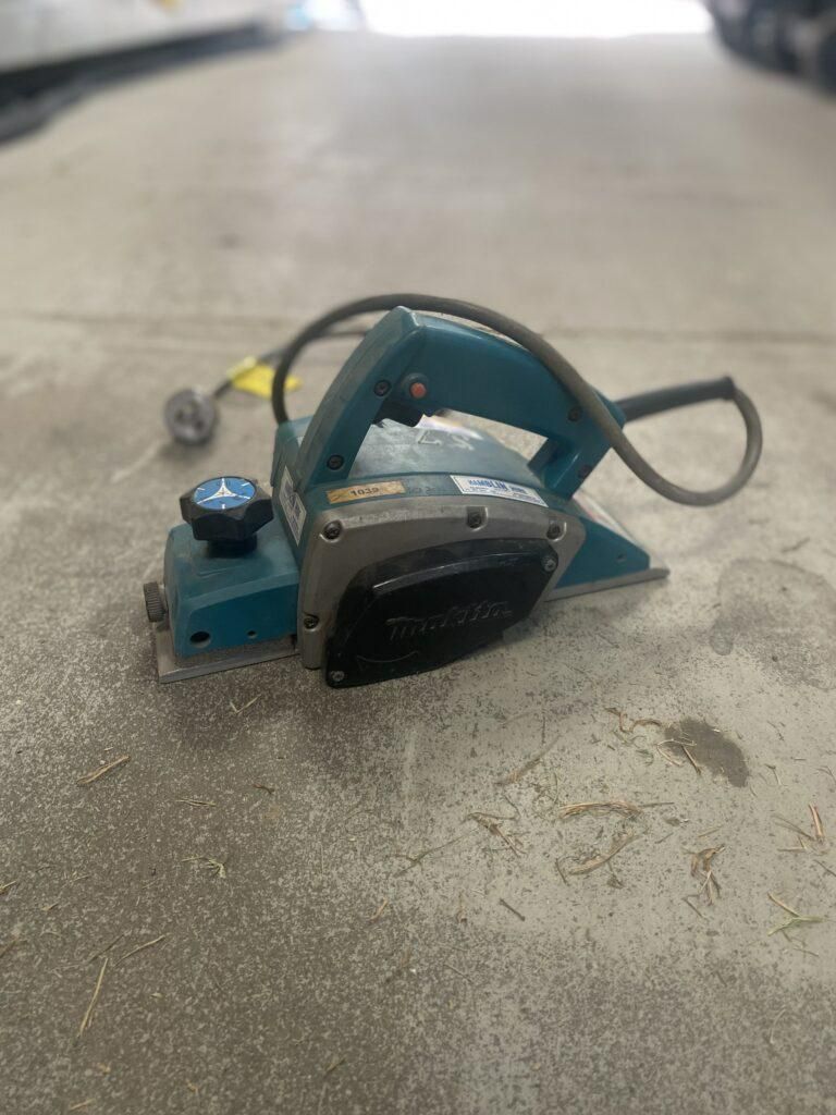 A Makita Planer is Sitting on a Concrete Floor — Hamblin Hire in Albury, NSW