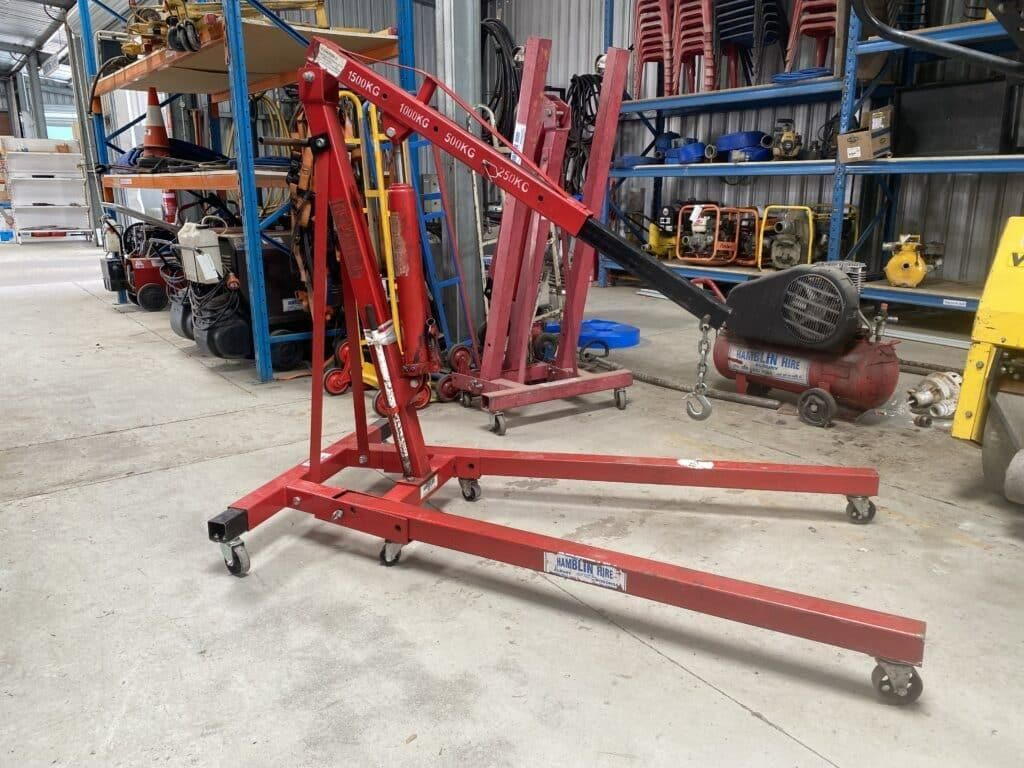 A Red Engine Crane is Sitting on the Floor in a Warehouse — Hamblin Hire in Albury, NSW