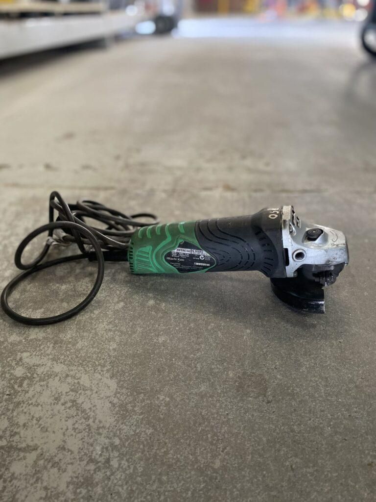 A Grinder is Sitting on a Concrete Floor — Hamblin Hire in Albury, NSW