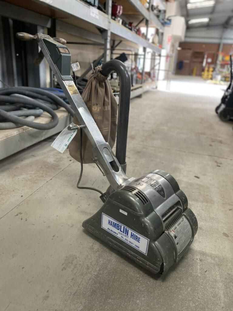 A Vacuum Cleaner is Sitting on a Concrete Floor in a Warehouse — Hamblin Hire in Albury, NSW