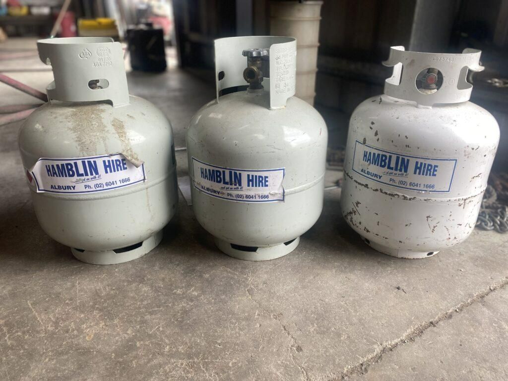 Three Gas Cylinders Are Sitting Next to Each Other on the Floor — Hamblin Hire in Albury, NSW