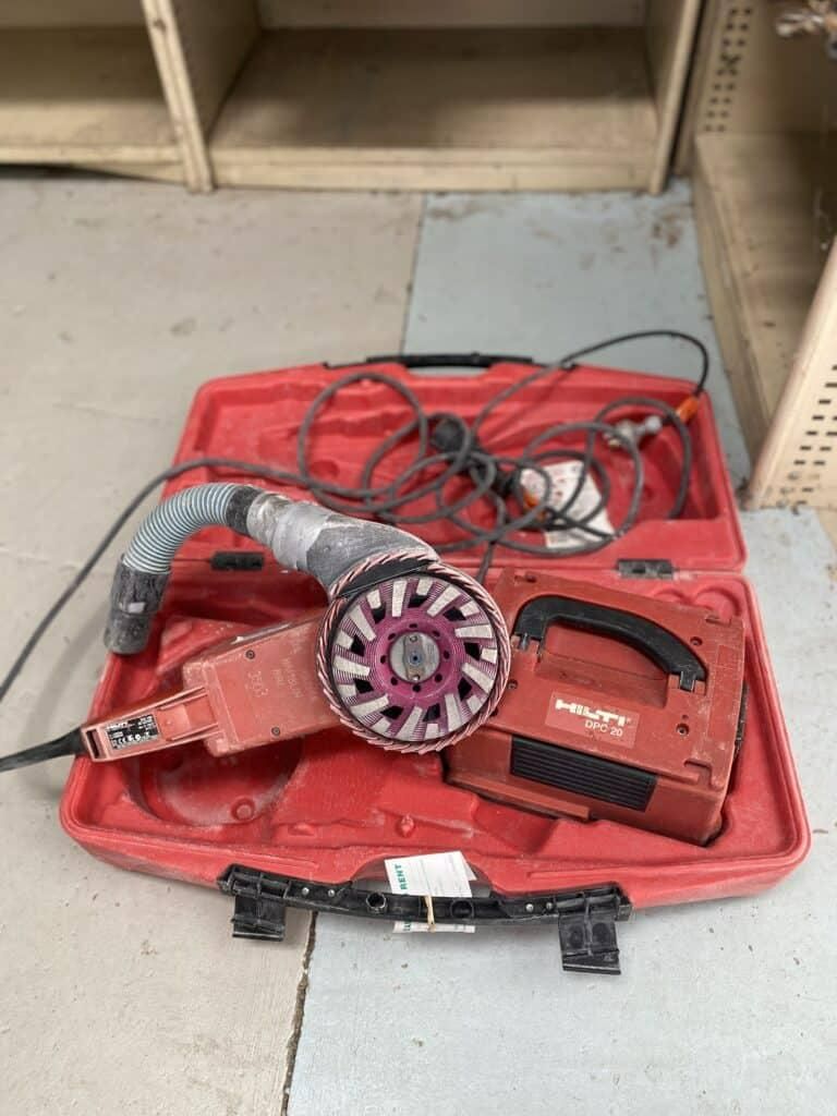 A Grinder is Sitting in a Red Case on the Floor — Hamblin Hire in Albury, NSW