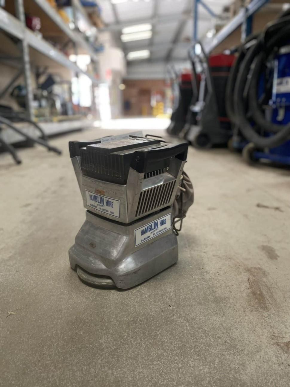 A Sander is Sitting on the Floor in a Warehouse — Hamblin Hire in Albury, NSW