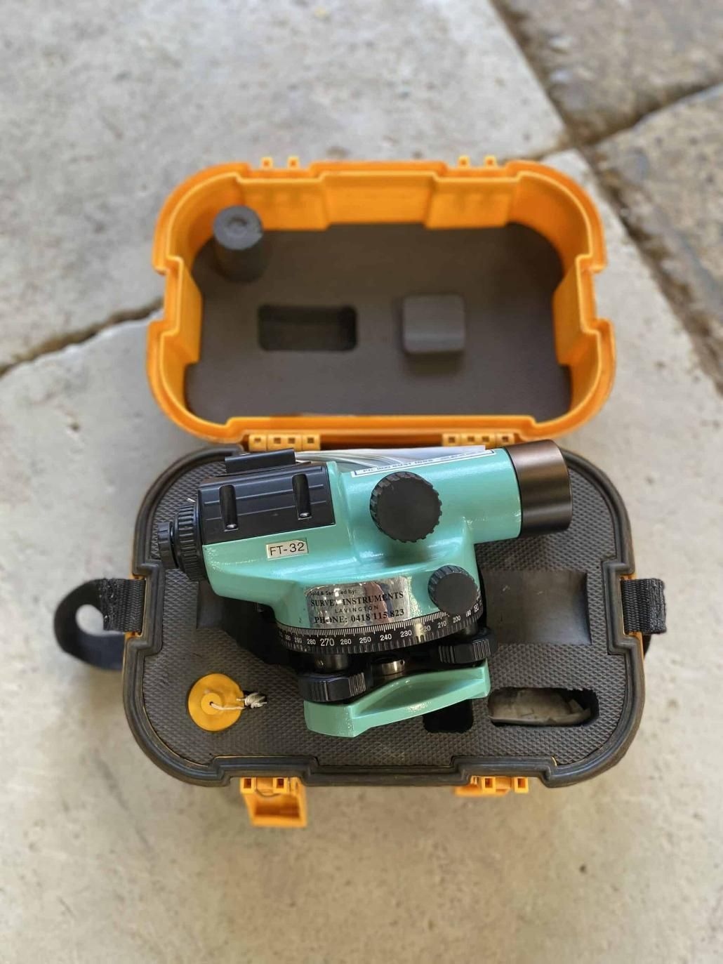 A Green Level in a Yellow Case on a Sidewalk — Hamblin Hire in Albury, NSW