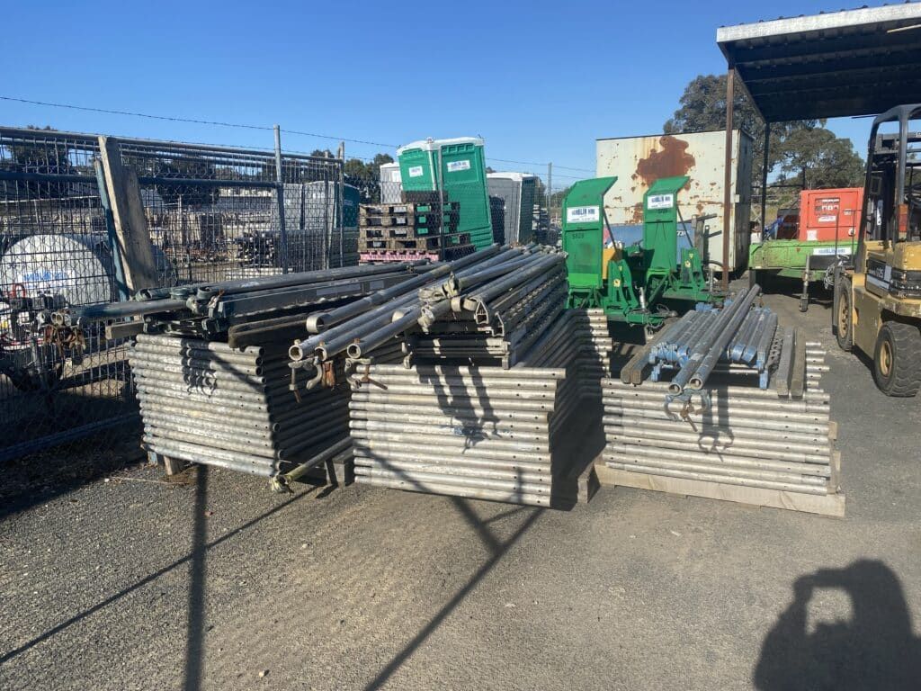A Bunch of Metal Pipes Are Stacked on Top of Each Other — Hamblin Hire in Albury, NSW