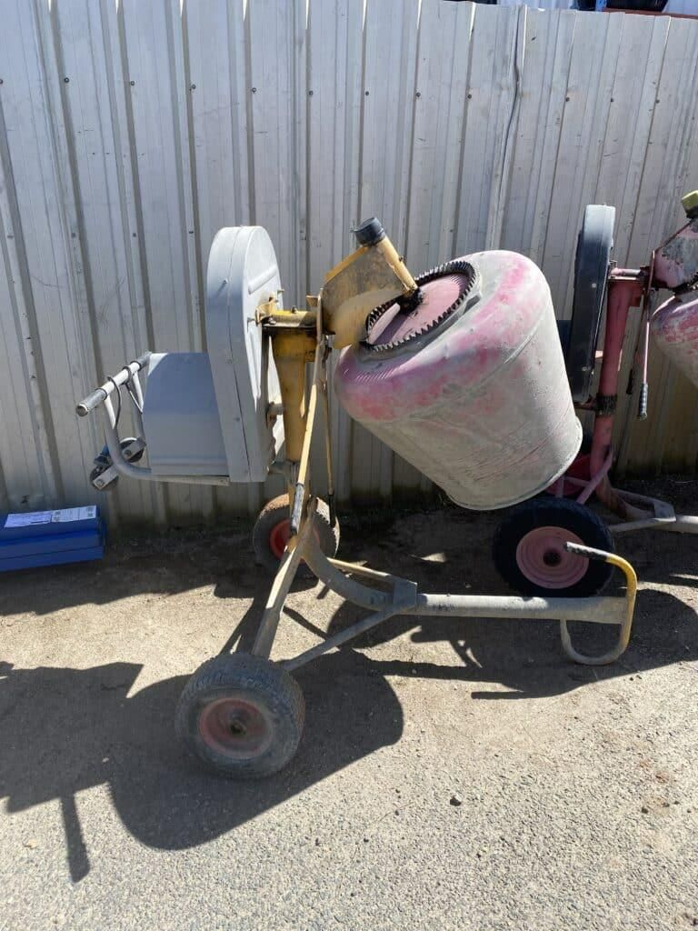A Concrete Mixer is Parked in Front of a White Fence — Hamblin Hire in Albury, NSW