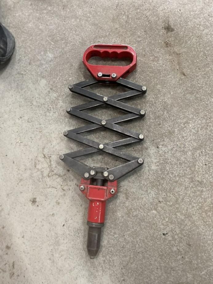 A Red and Black Tool is Sitting on a Concrete Surface — Hamblin Hire in Albury, NSW