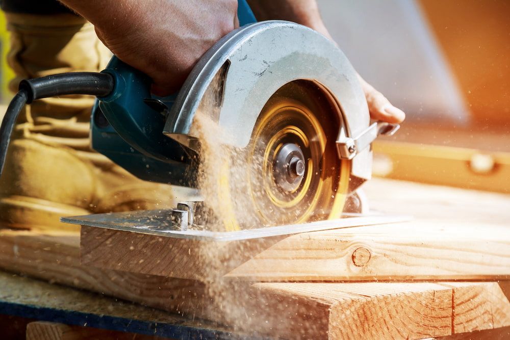 A Person is Using a Circular Saw to Cut a Piece of Wood — Hamblin Hire in Albury, NSW