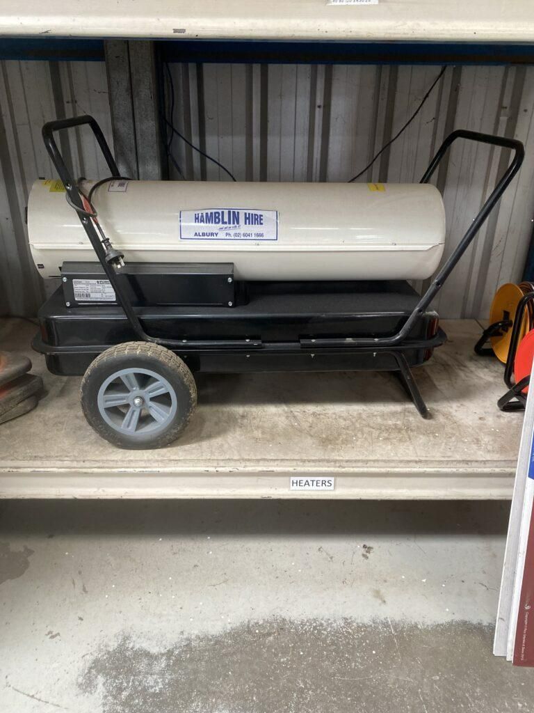 A Heater With Wheels is Sitting on Top of a Shelf — Hamblin Hire in Albury, NSW