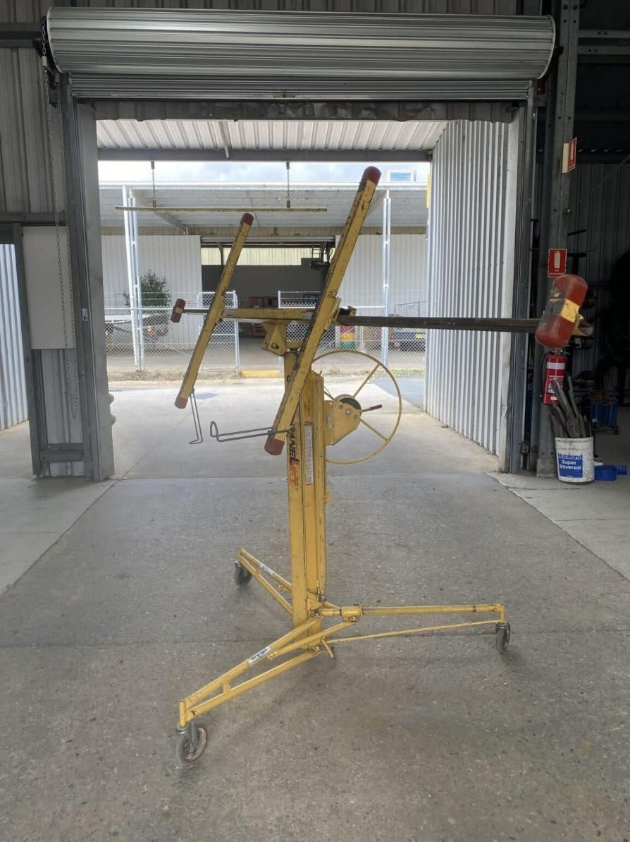 A Yellow Machine is Sitting in a Garage Next to a Garage Door — Hamblin Hire in Albury, NSW