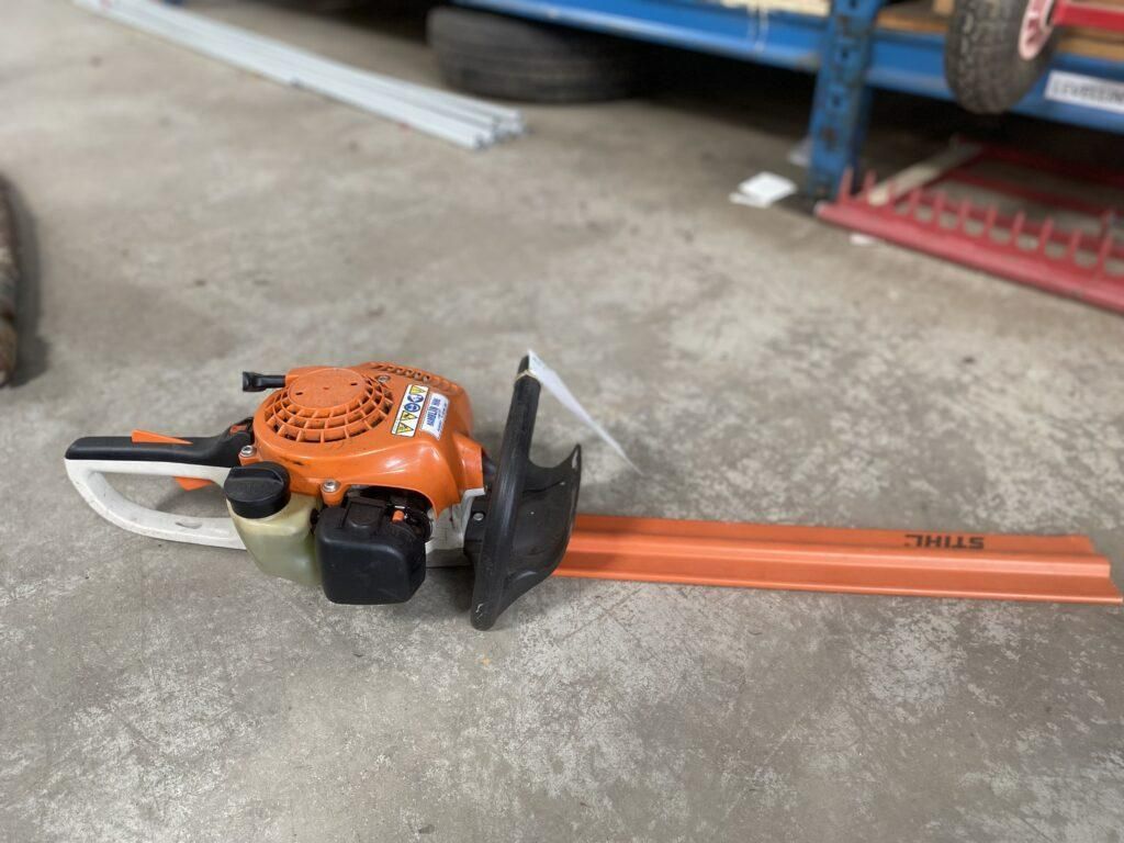 A Stihl Hedge Trimmer is Sitting on the Ground in a Garage — Hamblin Hire in Albury, NSW