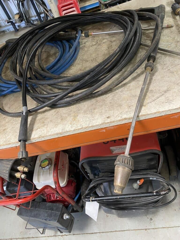 A High Pressure Washer With a Hose Attached to It is Sitting on a Table — Hamblin Hire in Albury, NSW