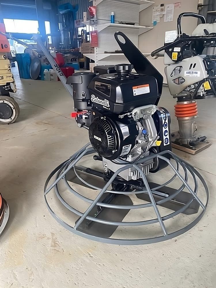 A Motor is Sitting on Top of a Concrete Trowel in a Garage — Hamblin Hire in Albury, NSW