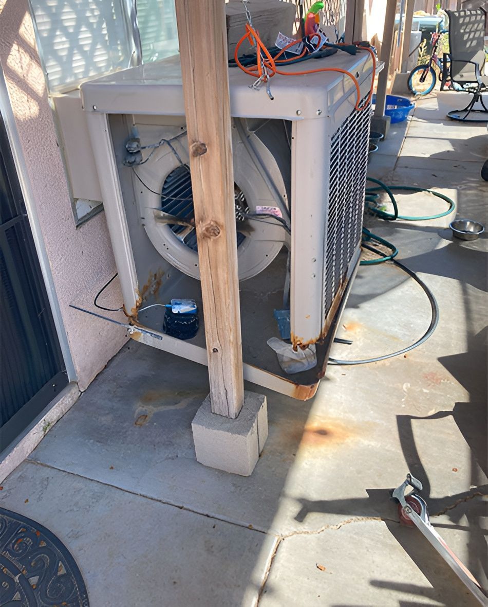 Evaporative cooler next to a support beam on a concrete patio.